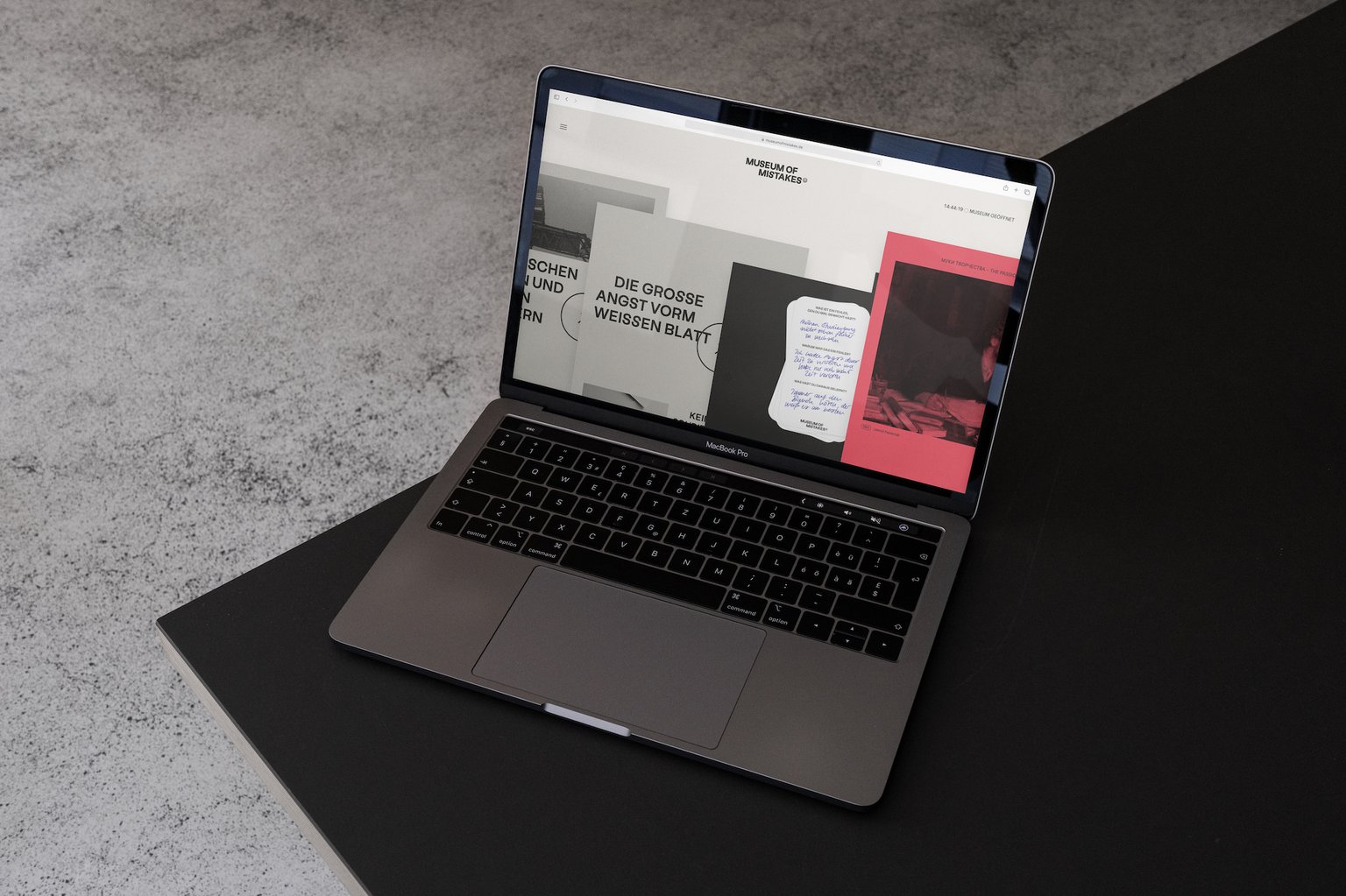 Laptop on a black table showing the Museum of Mistakes website